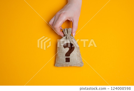 Hand holding a bag with a question mark. Financial uncertainty, hidden wealth, or unknown investment outcomes. Risky ventures, surprise rewards, or the unpredictability of economic decisions. Hand holding a bag with a question mark. Financial uncertainty, hidden wealth, or unknown investment outcomes. Risky ventures, surprise rewards, or the unpredictability of economic decisions. 124008598