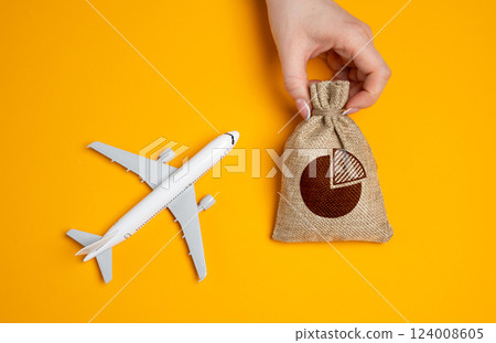 Passenger plane and a bag with a budget. Concept of budgeting, distribution of funds and investments. Airline expenses, investment strategies, and cost of flight operations. Travel budgeting 124008605