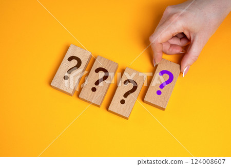 The hand selects unknown options from those presented. Quiz. Unknown prizes and promotion. Secrets and mysteries. Surprise rewards, prize draws, or hidden outcomes in contests. 124008607