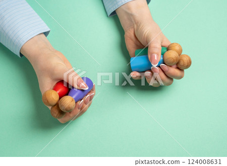 Woman holding figures of people. Concept of personnel management, hiring workers and delegation of tasks. Team building, staffing solutions, or effective workplace organization. Woman holding figures of people. Concept of personnel management, hiring workers and delegation of tasks. Team building, staffing solutions, or effective workplace organization. 124008631