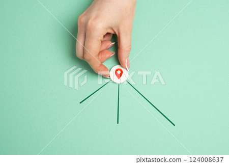 Hand with geolocation icon and new directions for next destinations. Navigation, exploring new destinations, planning travel routes. GPS services, mapping travel guidance Hand with geolocation icon and new directions for next destinations. Navigation, exploring new destinations, planning travel routes. GPS services, mapping travel guidance 124008637