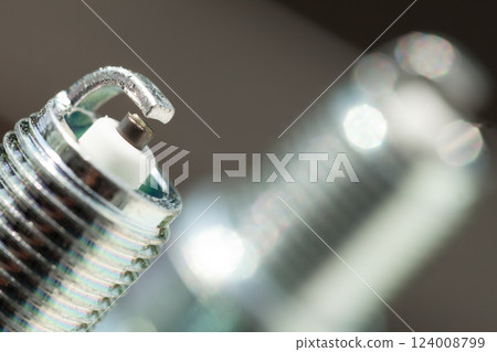 Auto service. Two new spark plugs as spare part of car. Auto service. Two new spark plugs as spare part of car. 124008799