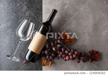 Red wine with grapes on a stone background. Red wine with grapes on a stone background. 124009282