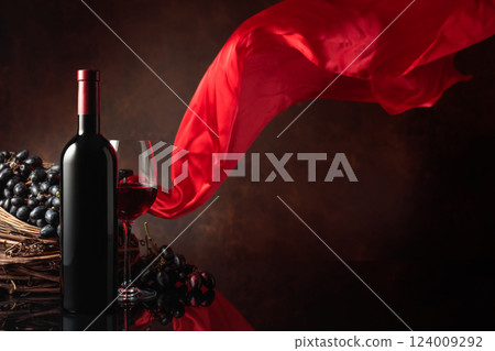 Red wine with grapes on a background of red flutters curtain. Red wine with grapes on a background of red flutters curtain. 124009292