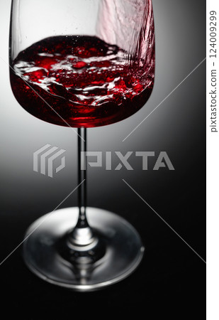 Closeup of red wine pouring. 124009299