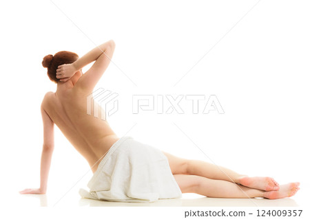 Sitting naked woman in white towel 124009357