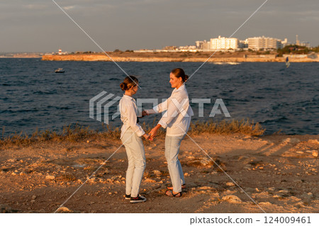 Women Holding Hands Beach Sunset Landscape 124009461