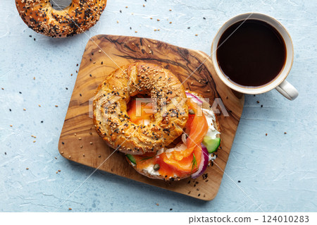 Lox bagel. A breakfast of a sandwich with smoked salmon and veggies Lox bagel. A breakfast of a sandwich with smoked salmon and veggies 124010283