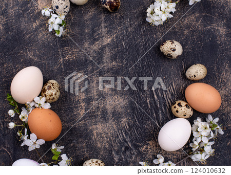 Chicken and quail eggs with blooming branch 124010632