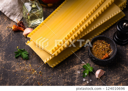 Uncooked lasagna pasta with cooking ingredient 124010696