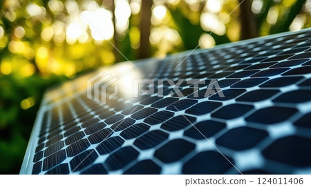 Solar panel close-up showcasing photovoltaic cells and sunlight reflections among greenery 124011406