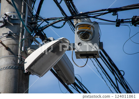 Security cameras and street lights in a residential area 124011861