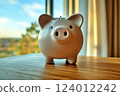Scenery of a piggy bank placed on a desk by the window 124012242