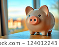 Scenery of a piggy bank placed on a desk by the window 124012243