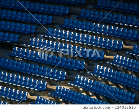 A large number of seats in a stadium A large number of seats in a stadium 124012610