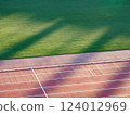Well-maintained stadium grass and track 124012969