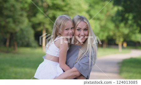 A truly heartwarming and joyful moment shared between a loving mother and her daughter while enjoying time outdoors 124013085