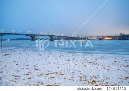 bank of frozen river and bridge in Kostroma city 124013320