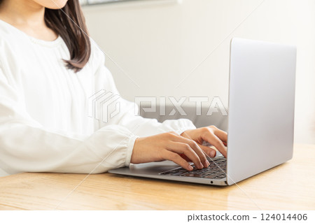 Asian woman's hands typing 06 124014406