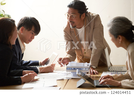Business people having a meeting led by an older leader 124014451