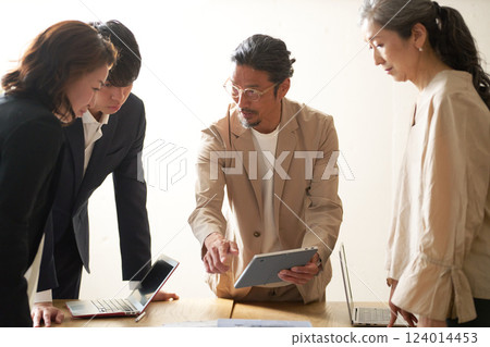 Business people having a meeting led by an older leader 124014453