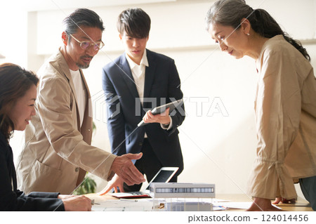 Business people having a meeting led by an older leader 124014456
