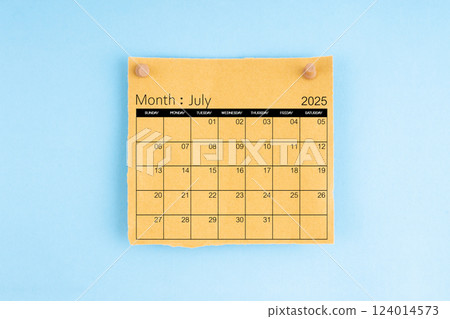 July 2025 brown calendar with wooden thumbtack on blue background. July 2025 brown calendar with wooden thumbtack on blue background. 124014573