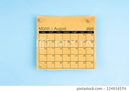 August 2025 brown calendar with wooden thumbtack on blue background. 124014574