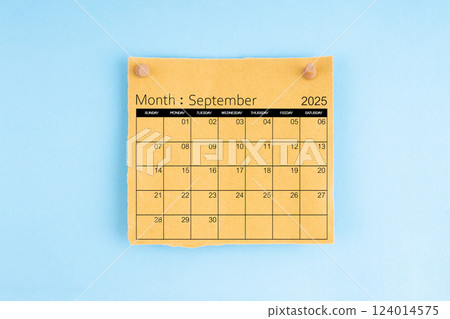 September 2025 brown calendar with wooden thumbtack on blue background. 124014575