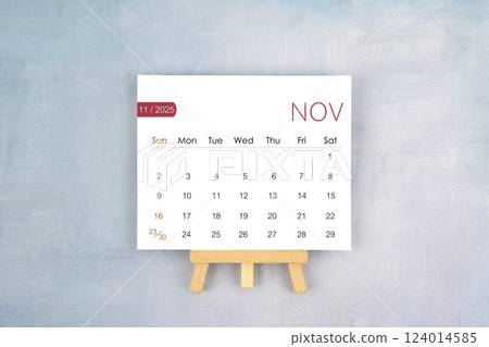 November 2025 calendar page with wooden easel. 124014585