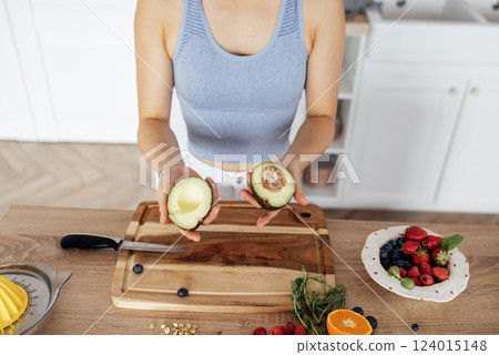 Asian woman smiles and cooks breakfast in the kitchen 124015148