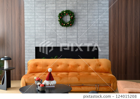 Cozy living room with orange sofa and festive wreath decor Cozy living room with orange sofa and festive wreath decor 124015208
