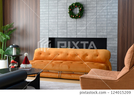 Cozy living room with orange sofa and festive decor Cozy living room with orange sofa and festive decor 124015209