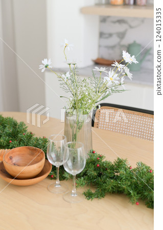 Festive table decor with flowers and greenery arrangement 124015335