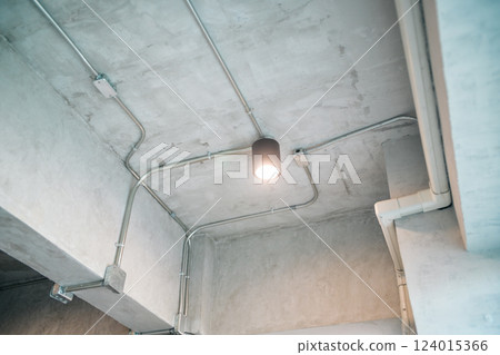 Exposed concrete ceiling with industrial light fixture Exposed concrete ceiling with industrial light fixture 124015366