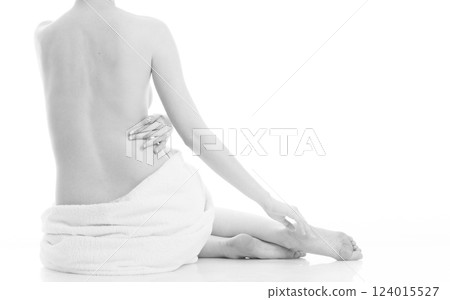 Sitting naked woman in white towel Sitting naked woman in white towel 124015527