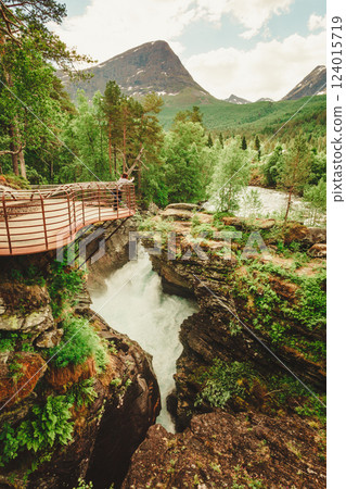Tourist with camera on Gudbrandsjuvet waterfall, Norway Tourist with camera on Gudbrandsjuvet waterfall, Norway 124015719