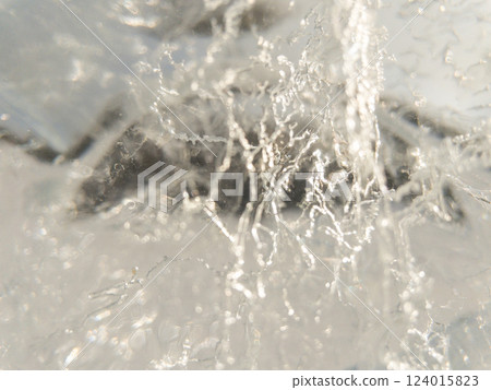 Ice texture background. Textured cold frosty surface of ice block with frozen air bubbles. 124015823