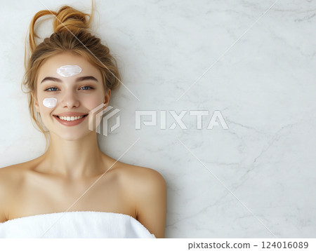 A woman with a white towel on her chest A woman with a white towel on her chest 124016089