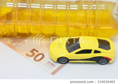 A bottle of vegetable oil and a typewriter lie on a banknote. Biodiesel, biofuel, vegetable oil A bottle of vegetable oil and a typewriter lie on a banknote. Biodiesel, biofuel, vegetable oil 124016465
