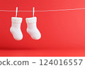 Warm woolen knitted white booties or socks for newborn baby on red background. Copy space, Generative ai 124016557
