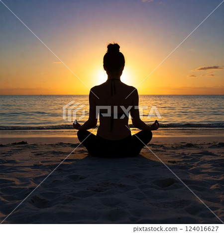 Silhouette of a woman doing yoga on the beach at sunrise 124016627