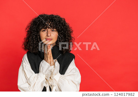 Caucasian young woman praying making wish, asking hopeful help begging apology meditation imploring Caucasian young woman praying making wish, asking hopeful help begging apology meditation imploring 124017982