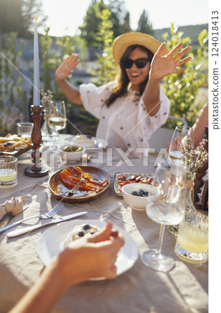 Happy female Anna Pavlova dessert. Glasses of wine and other dishes on the table 124018413