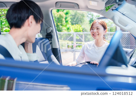 A young husband driving his wife home 124018512