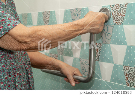 Asian elderly woman patient use toilet bathroom handle security in nursing hospital, healthy strong medical. 124018593
