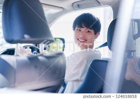 Young man enjoying a car drive Young man enjoying a car drive 124018658
