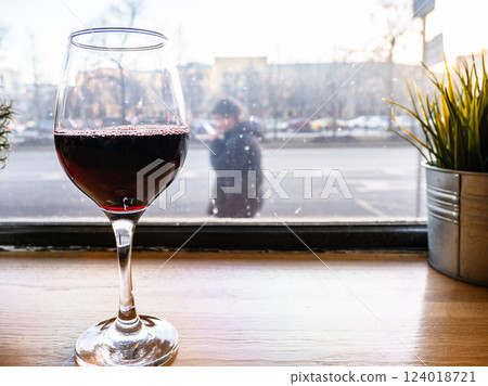 red wine glass on windowsill and view of cityscape red wine glass on windowsill and view of cityscape 124018721