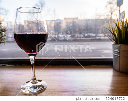 red wine glass on windowsill and view of city red wine glass on windowsill and view of city 124018722
