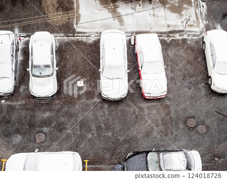top view of snow-covered cars in yard in winter top view of snow-covered cars in yard in winter 124018726